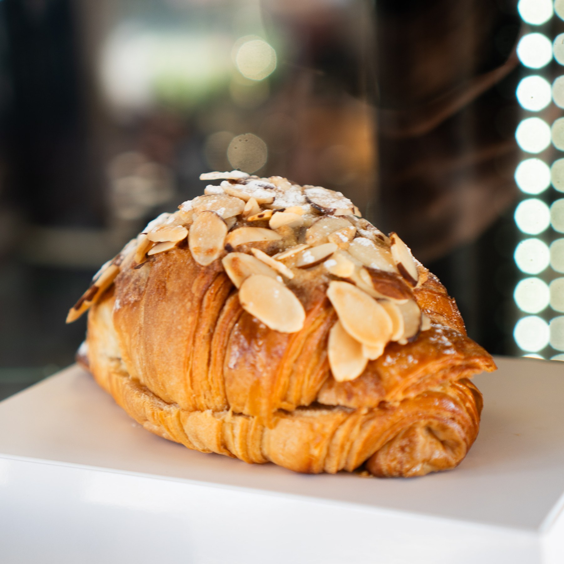 Almond croissant on a white plate at Cafe Hive.