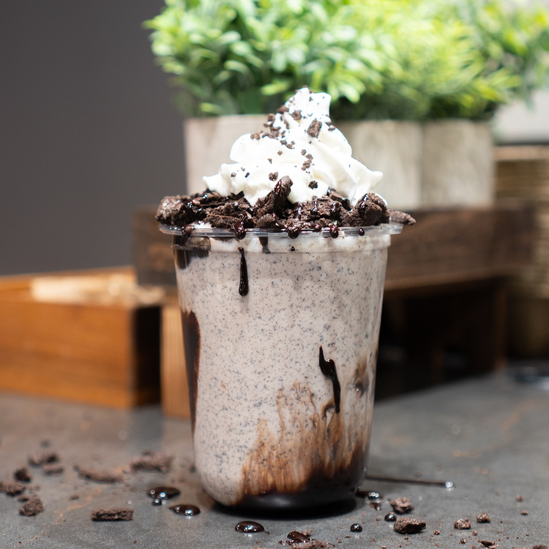 Cookies-and-cream milkshake with chocolate sauce and cookie pieces.