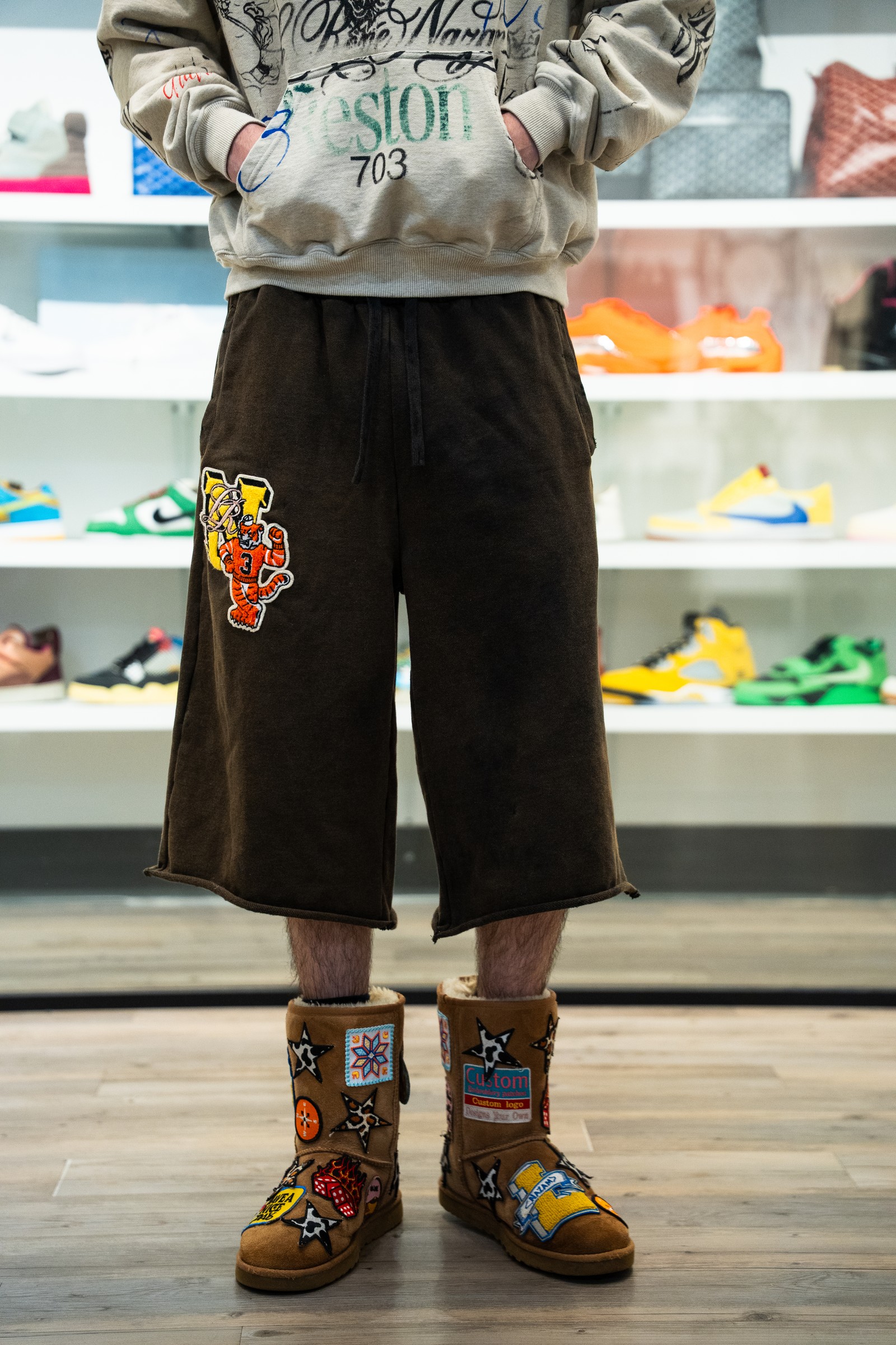 Styled hoodie, wide shorts and decorated boots worn inside Grandeur.