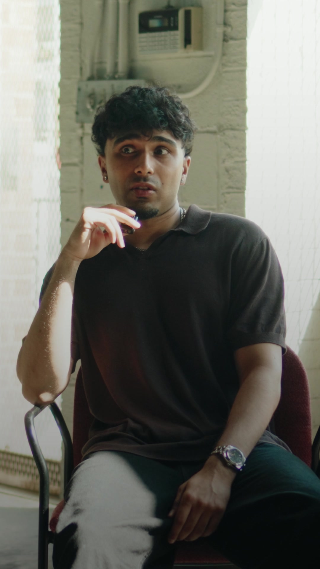 Jade seated beside white curtains in the founder documentary film
